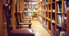 Empty chairs stacked in a college library